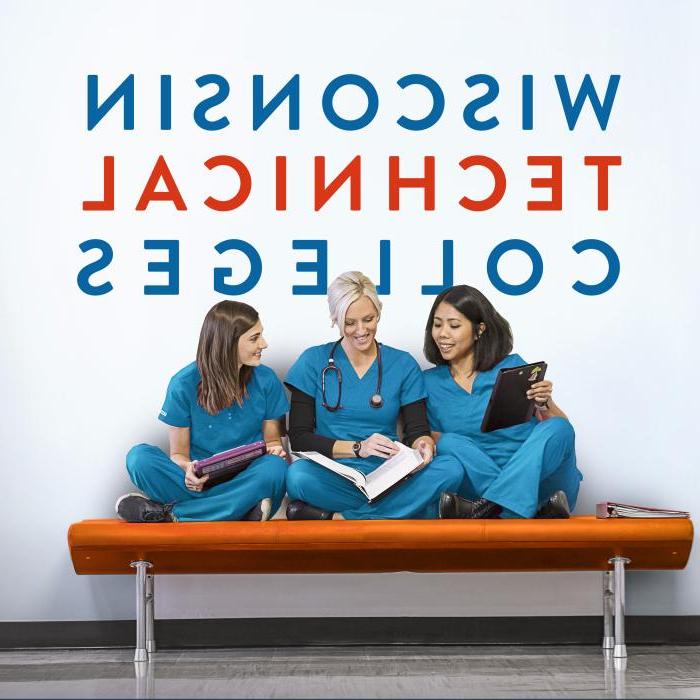 威斯康星技术学院 three nursing students talking and laughing on an orange hallway bench