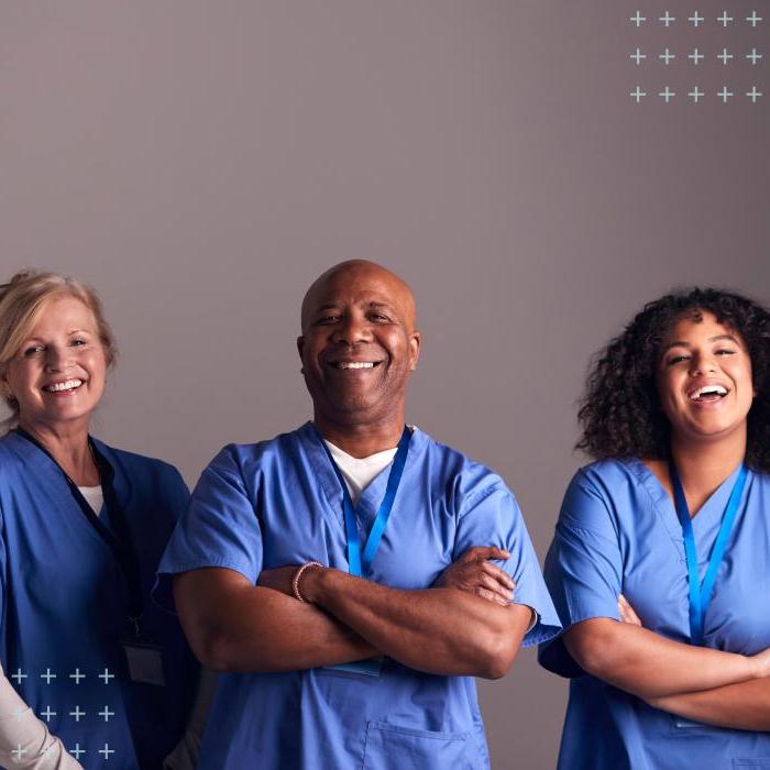 Two female and one male nurse anesthesiologist members of AANA wearing scrubs