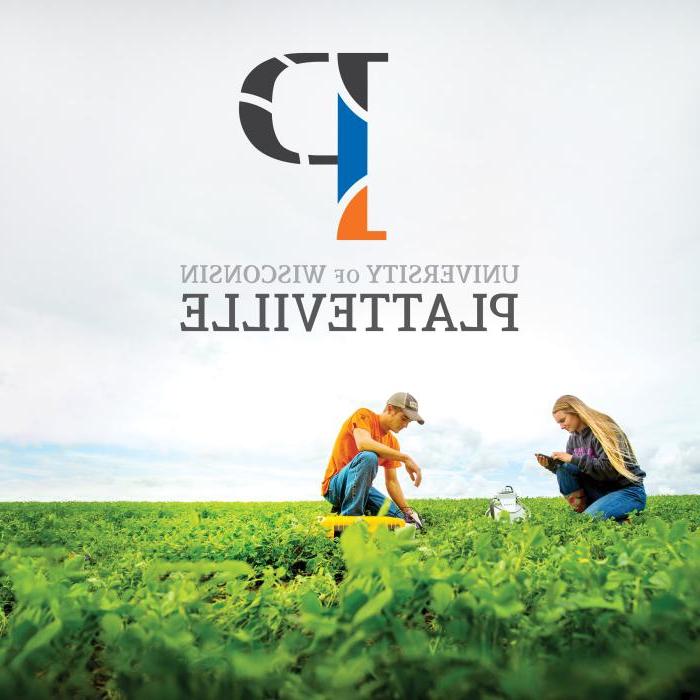 Two UW-Platteville students in a farm field, underneath the new P logo created by 十大网堵平台推荐